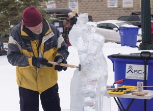 Dan Ingrebrigtson, of Franklin, chisels away to create his ice sculpture.